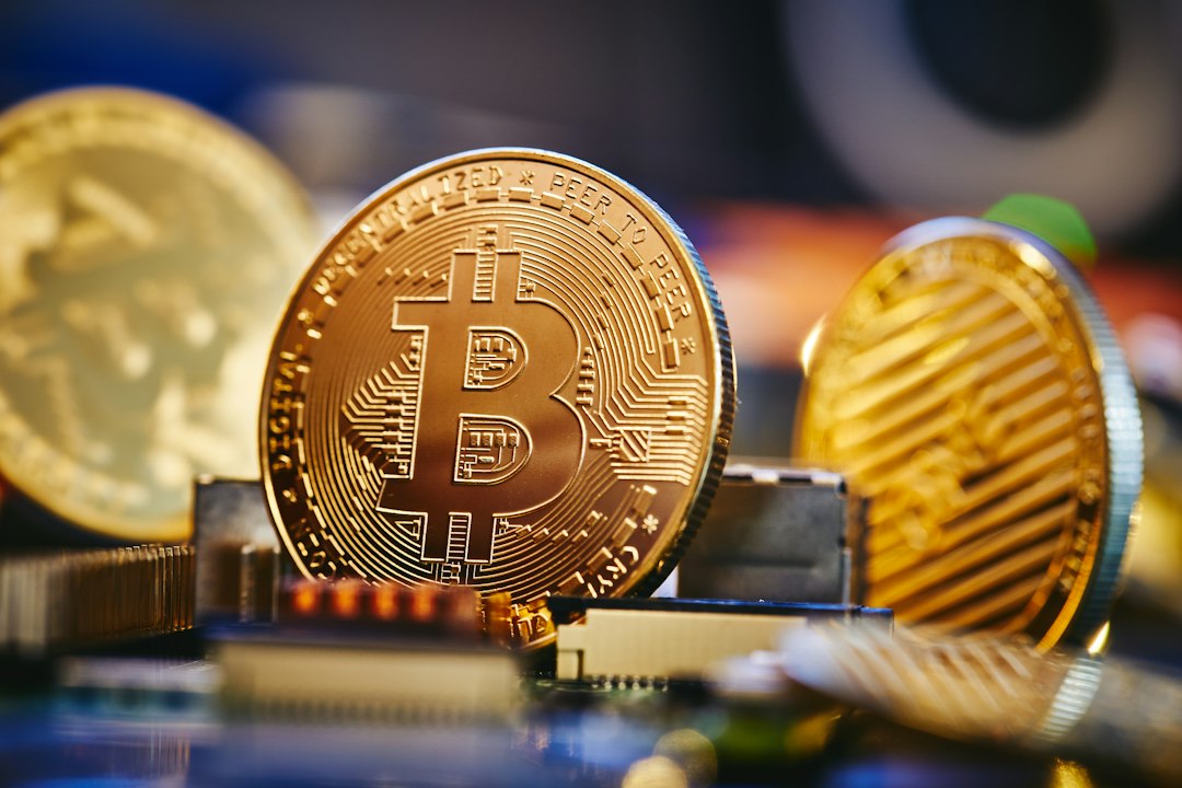 a bit coin sitting on top of a computer chip