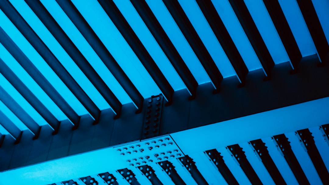 a close up of a metal structure with a blue light
