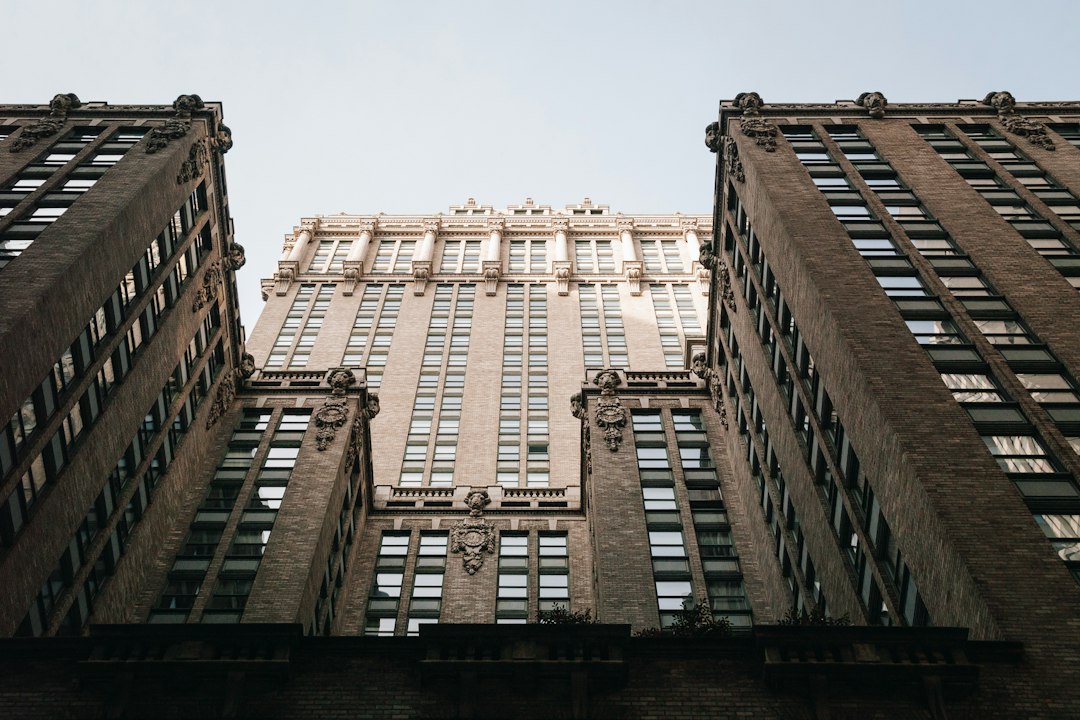 looking up at the top of two tall buildings