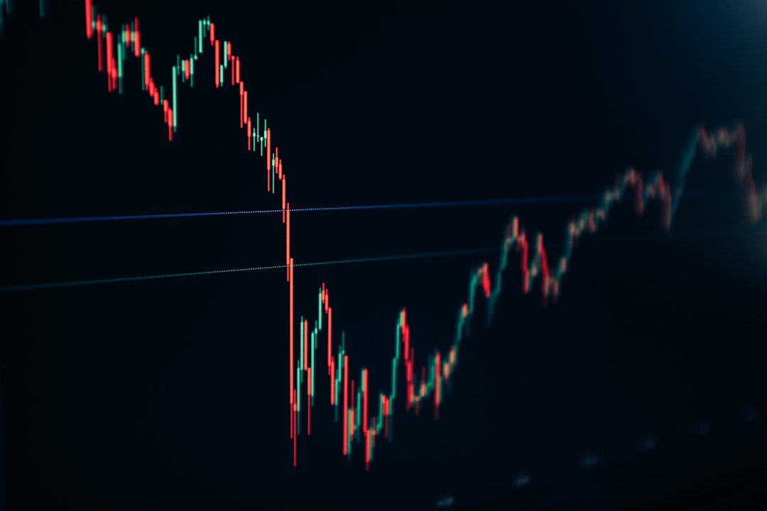 candlestick stock chart on dark screen