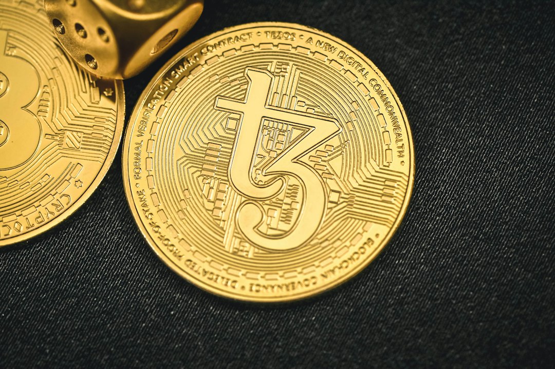 a close up of two gold bitcoins on a black surface